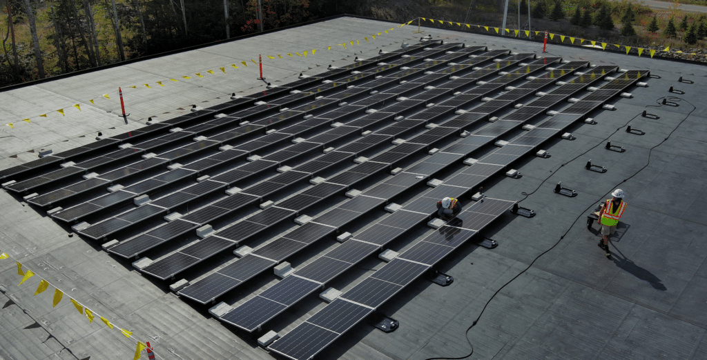 Solar panels installed on a flat commercial roof using a ballasted racking system