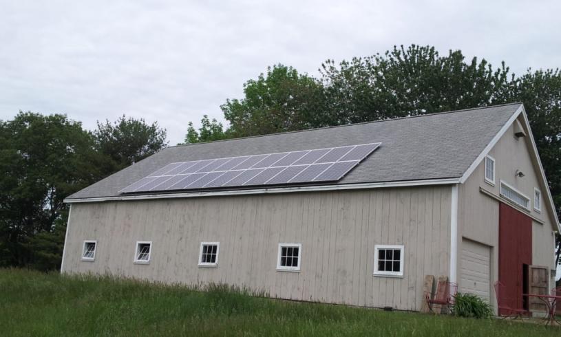 Outside of a Barn With Solar Panels on the Roof