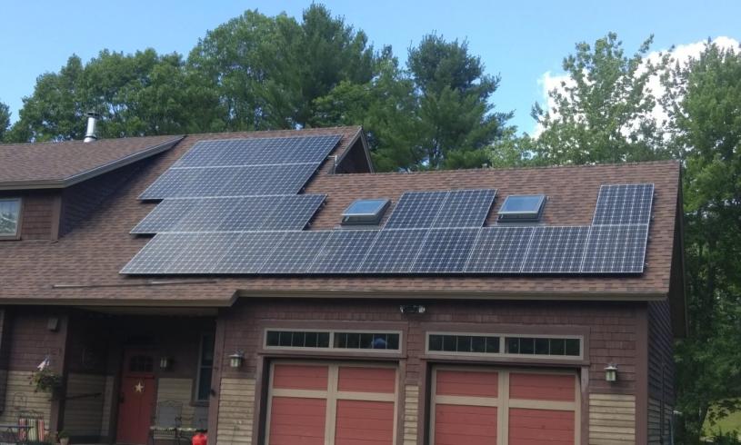 Outside of a Home With Solar Panels on the Roof