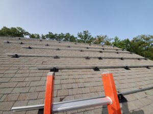 Solar installation crew on asphalt shingles — roof types for solar in Maine